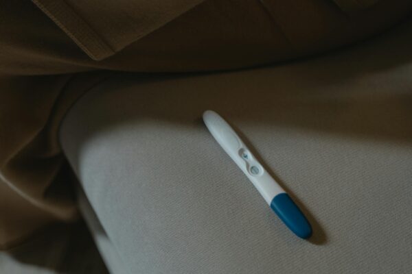 A close-up image of a pregnancy test resting on a soft fabric surface, symbolizing anticipation and new beginnings.